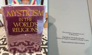 Book titled "Mysticism and the World's Religions" with copyright page visible.